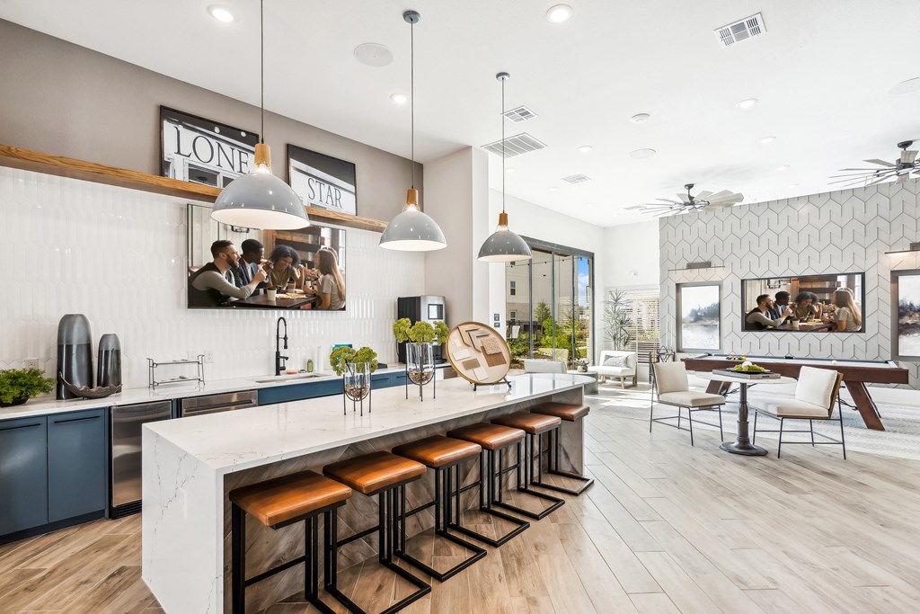a large kitchen with a counter top and stools