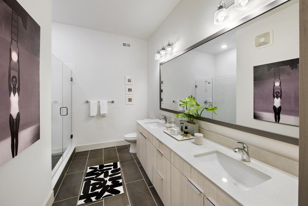 a bathroom with two sinks and a large mirror