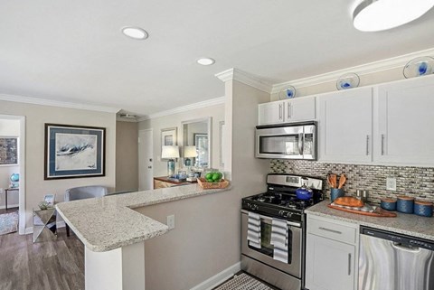 A kitchen with a stove top oven and a microwave above the counter.
