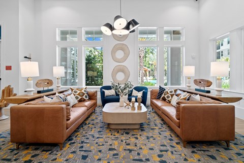 A living room with brown leather couches and a large rug.