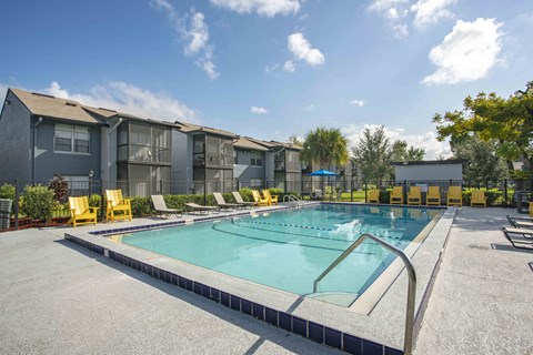 our apartments offer a swimming pool with yellow chairs around it