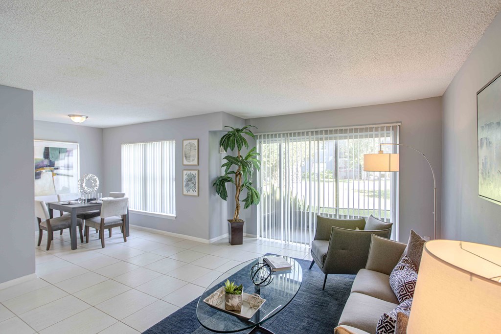 a living room with a couch and a glass table