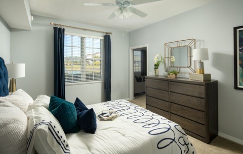 a bedroom with a large bed and a ceiling fan