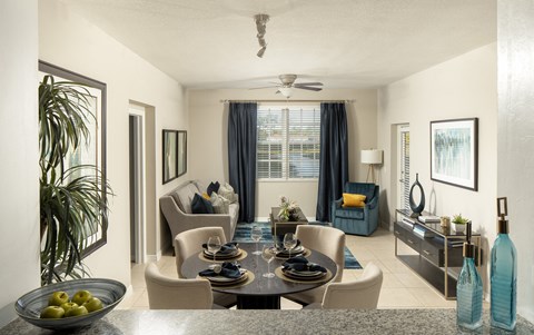a living room with a table and chairs and a couch