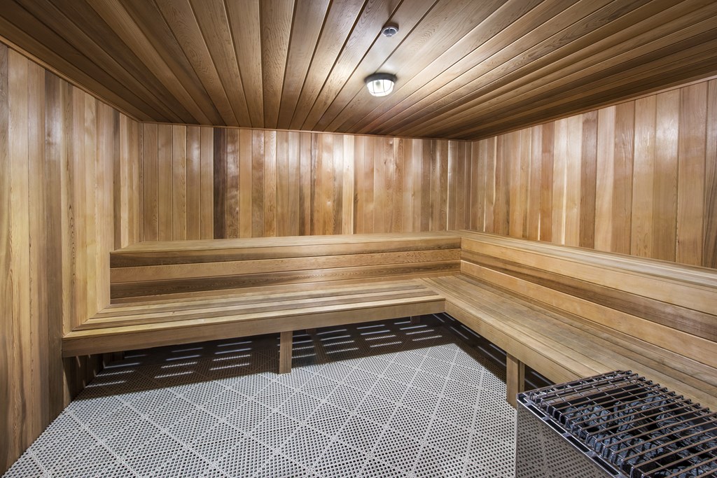 a sauna in a home gym with wood walls and flooring
