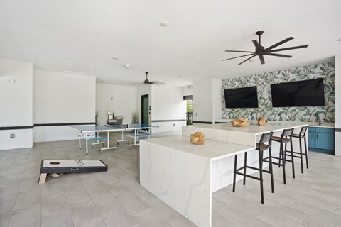 A kitchen with a white counter and a ceiling fan.