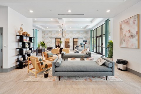 A modern living room with a grey sofa and wooden floors.