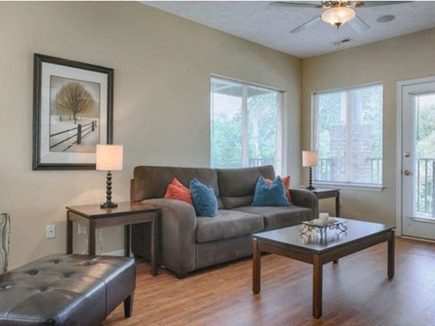 a living room with a couch and tables