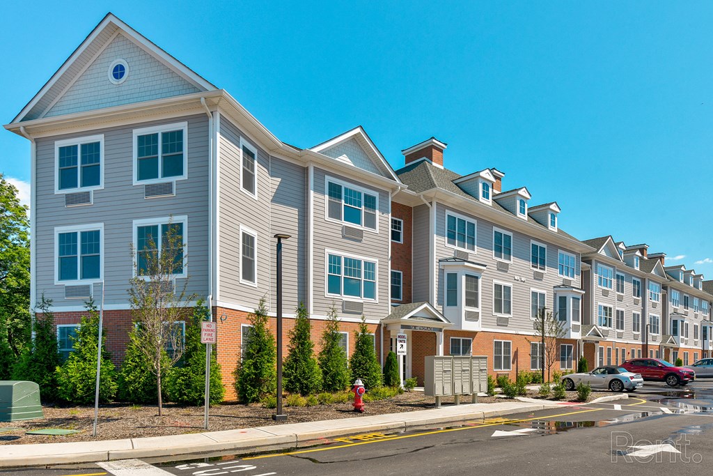 a row of apartment buildings on a city street  at Solo at North Bergen, North Bergen, NJ