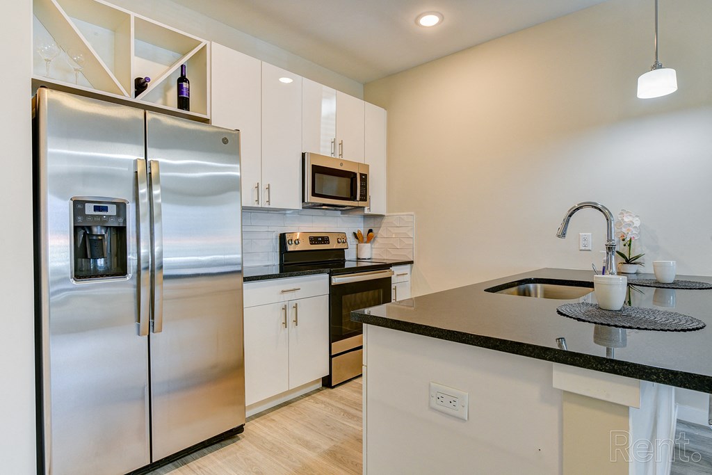 a kitchen with stainless steel appliances and a counter top at Solo at North Bergen, North Bergen