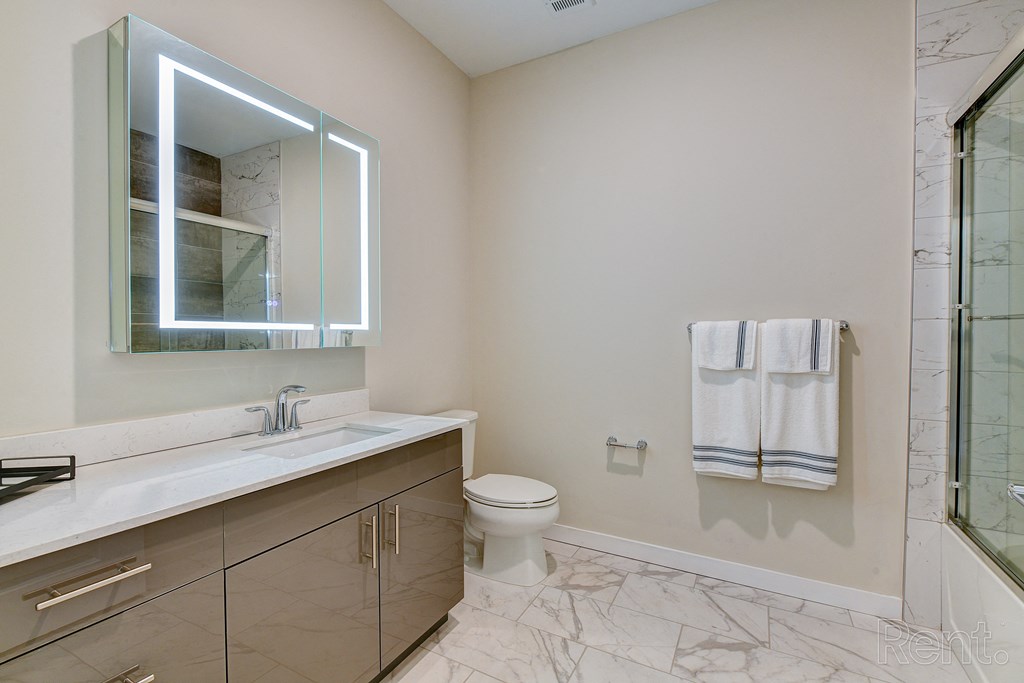 a bathroom with a mirror and a sink and a toilet at Solo at North Bergen, New Jersey