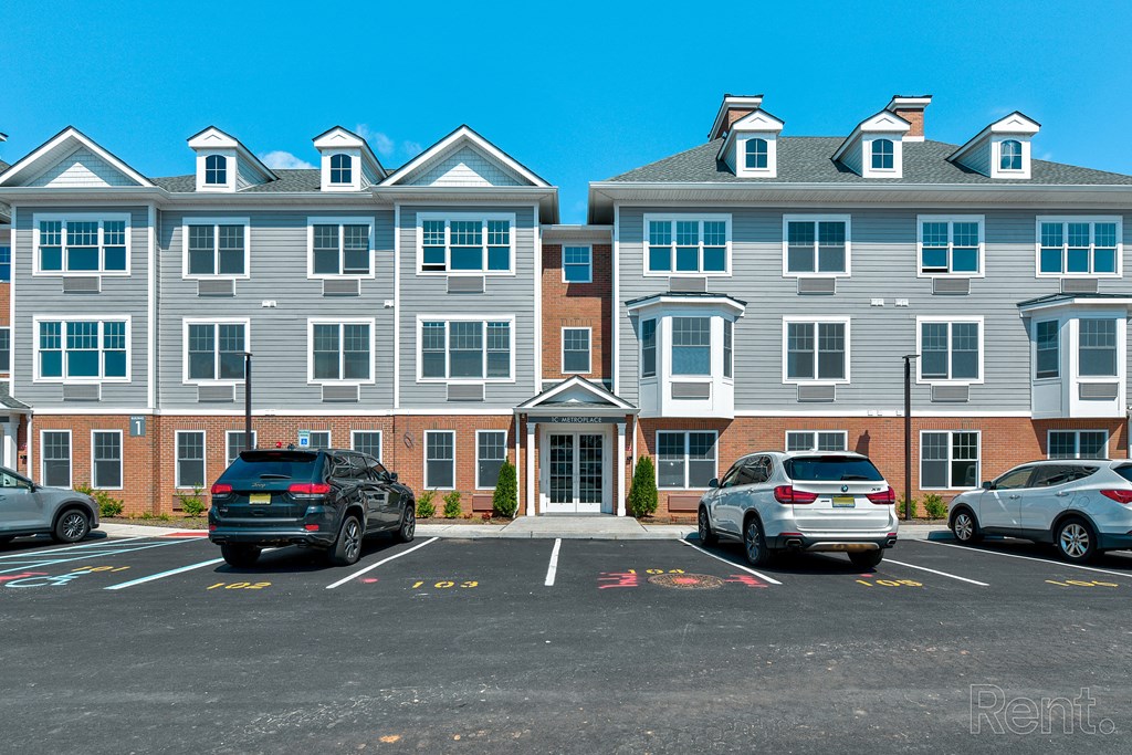 a parking lot in front of a large apartment building at Solo at North Bergen, North Bergen