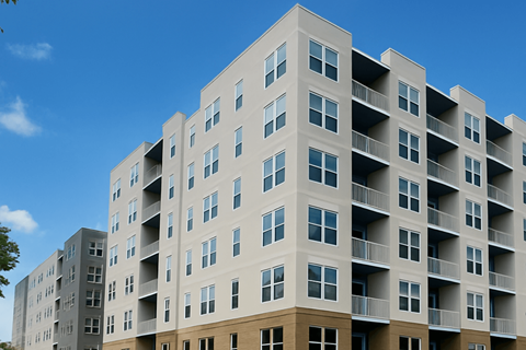 A large apartment building with balconies and multiple floors.