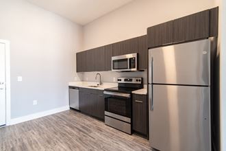 a kitchen with stainless steel appliances and a refrigerator