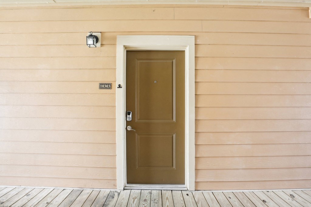 the front door of a house with a brown door