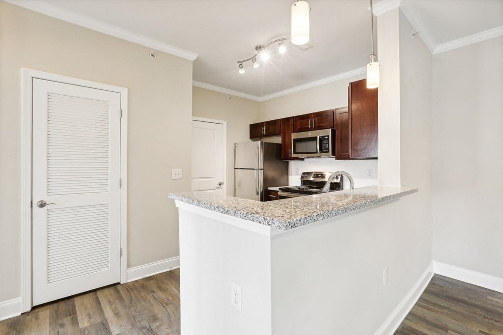 a kitchen with a granite counter top and a refrigerator