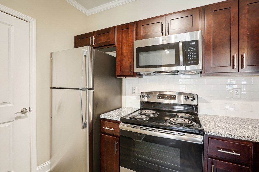 a kitchen with a stove microwave and refrigerator