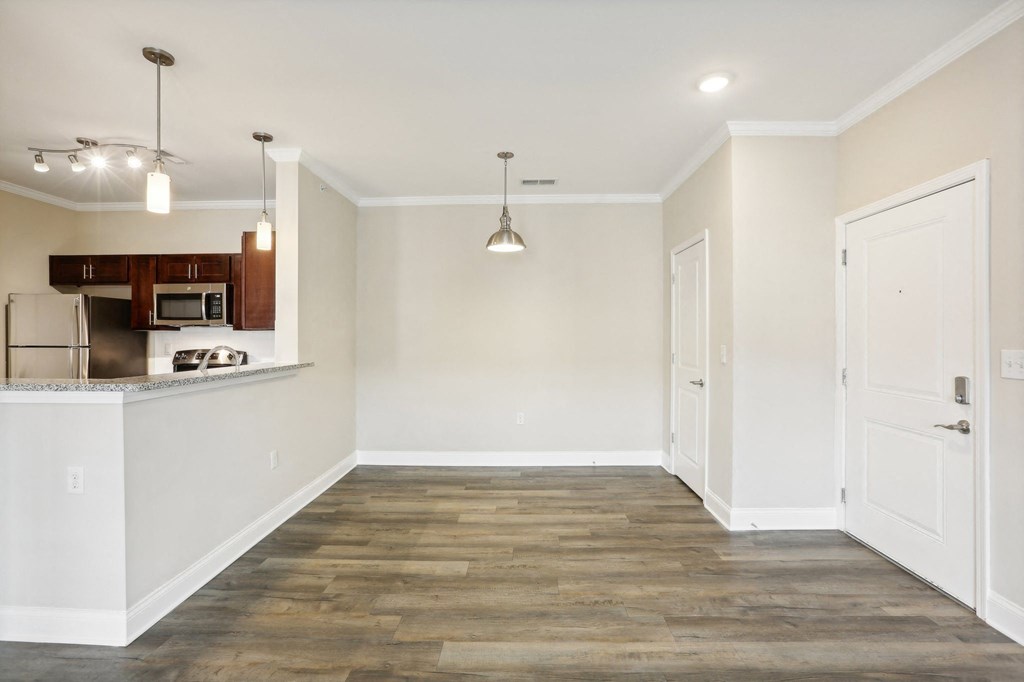 a renovated living room with white walls and wood flooring