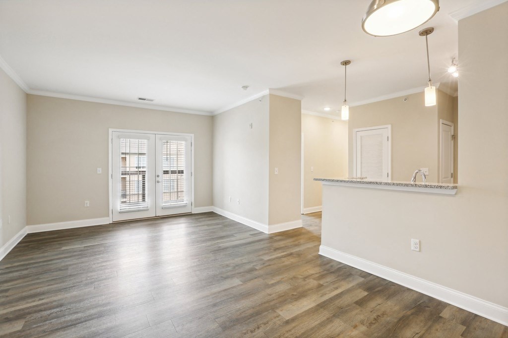 the living room and kitchen of a new home with wood flooring