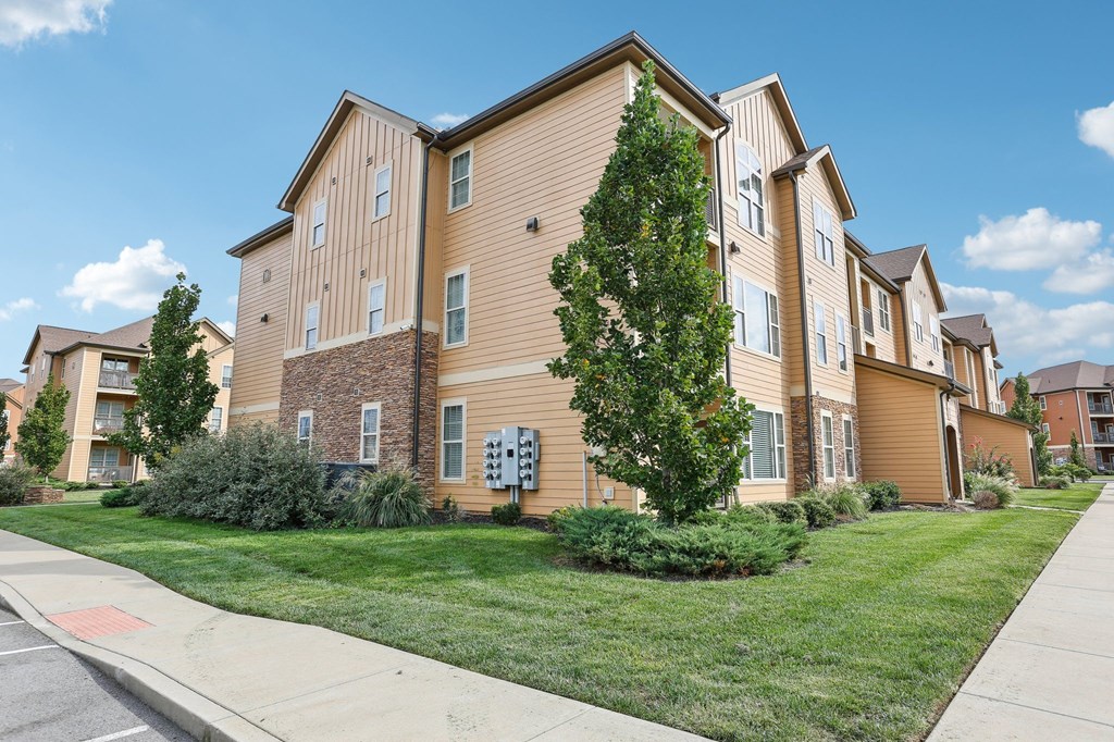 our apartments are located on the corner of a street with grass