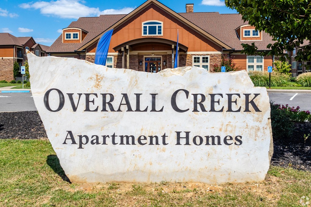 an overhead creek apartment homes sign in front of a house