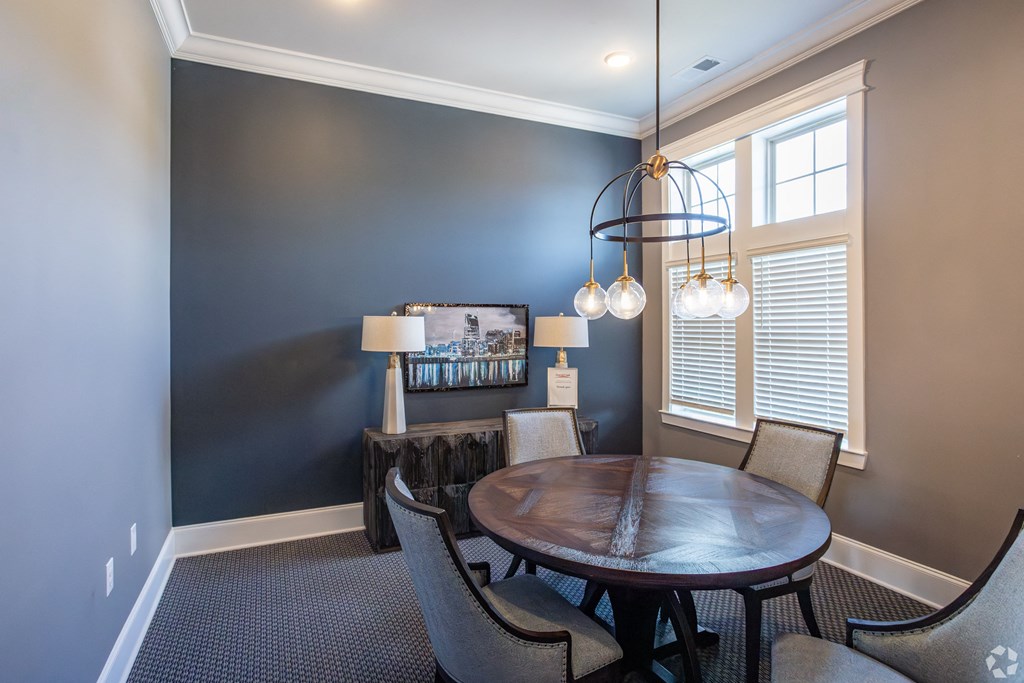 a dining room with a table and chairs and a chandelier
