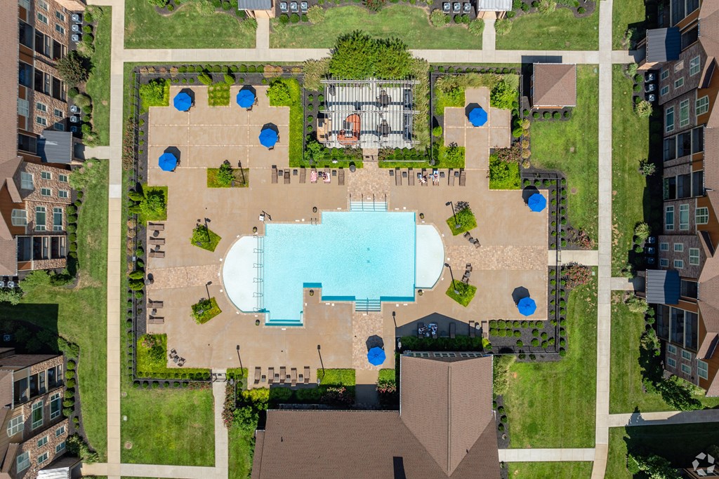 an overhead view of a building with a pool in the middle