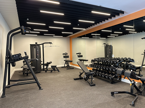 Modern fitness center at The Rail at Bound Brook featuring open space, natural light, and top-tier workout amenities for luxury apartment residents near NJ Transit.