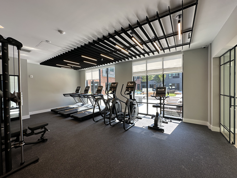 State-of-the-art fitness center with cardio and weight machines at The Rail at Bound Brook, designed to support active lifestyles in Downtown Bound Brook apartments.