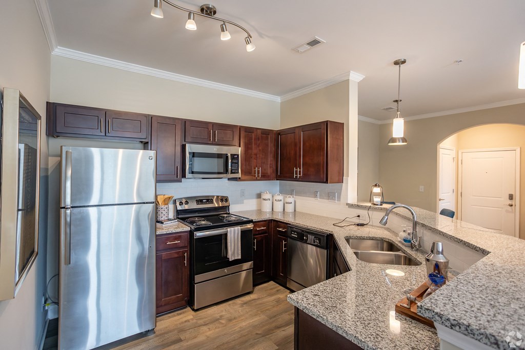 a kitchen with stainless steel appliances and granite counter tops