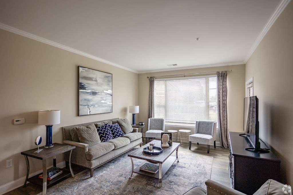 a living room with a couch and chairs and a table