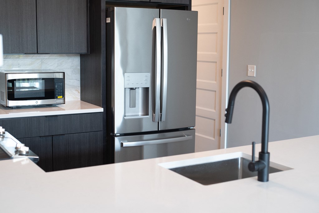 a kitchen with a sink and a refrigerator