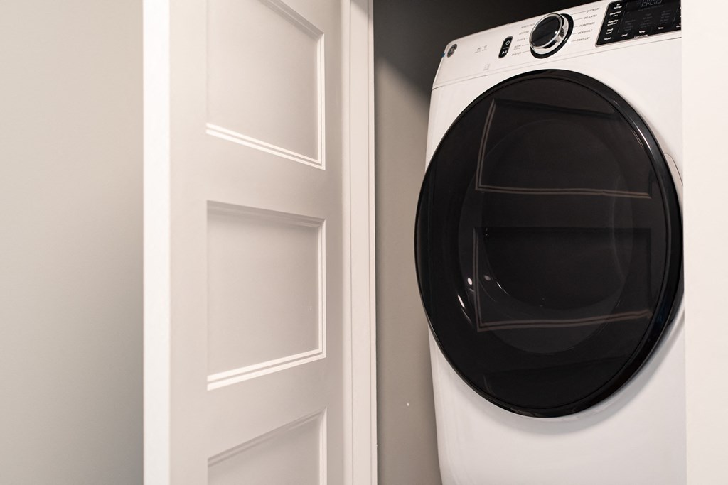 a white washer and dryer next to a white door