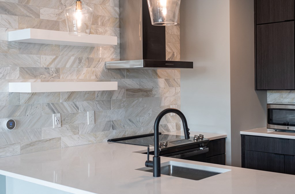 a kitchen counter with a sink and a faucet