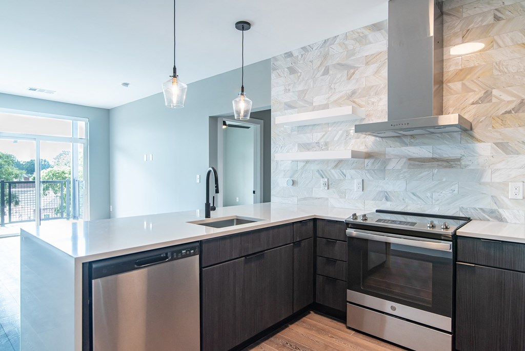 a kitchen with an island and a stove and a window