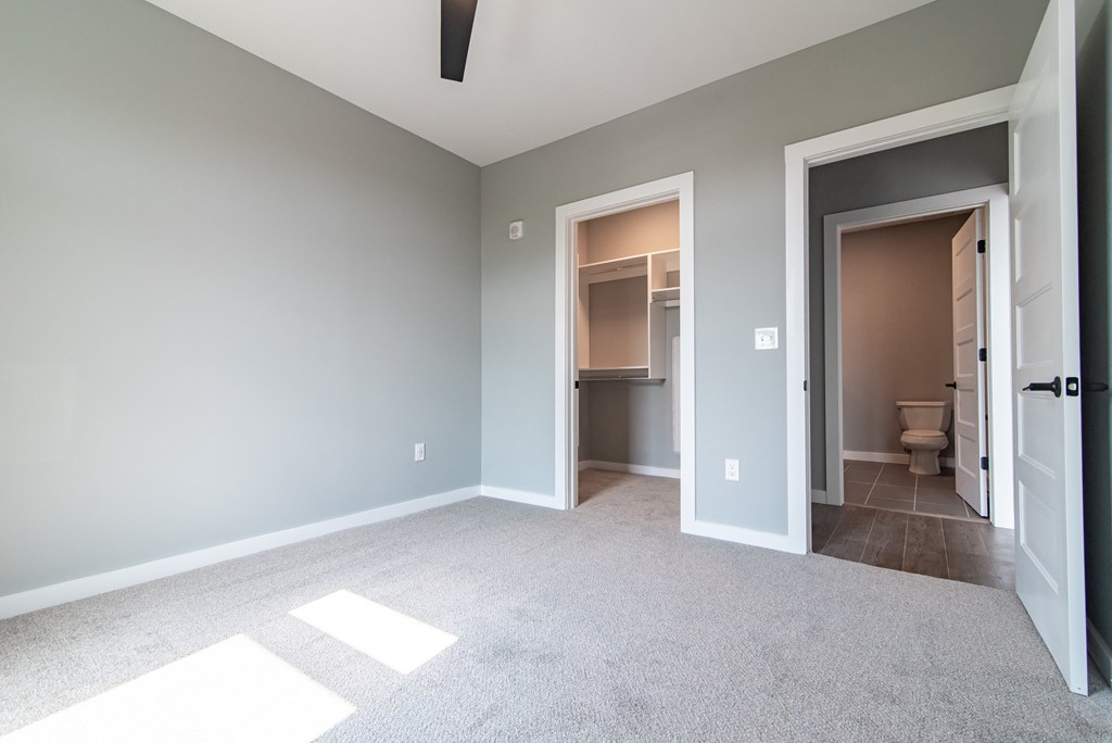 an empty bedroom and bathroom in a new home