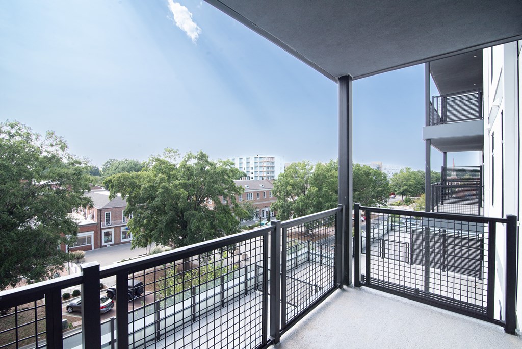 a balcony with a view of trees and a city