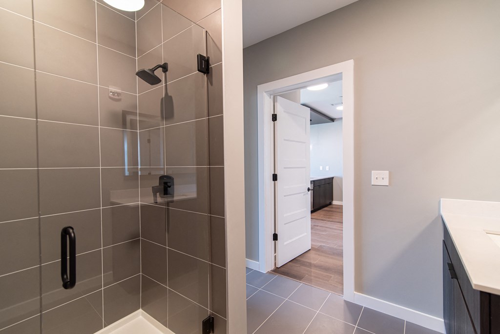 a view of a bathroom with a shower and a sink
