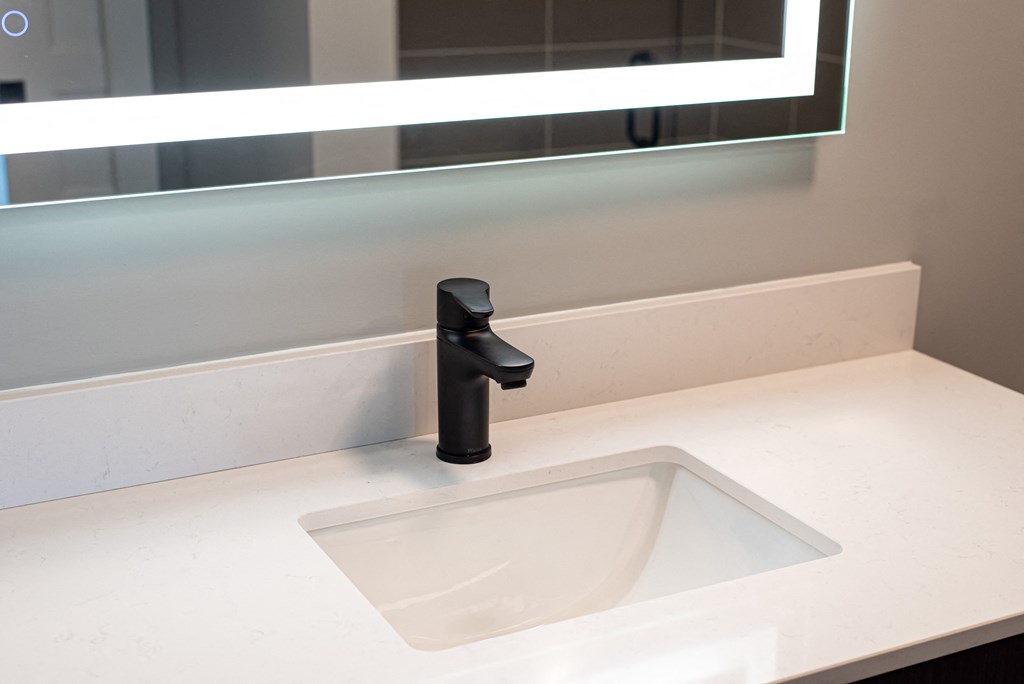 a sink in a bathroom with a black faucet
