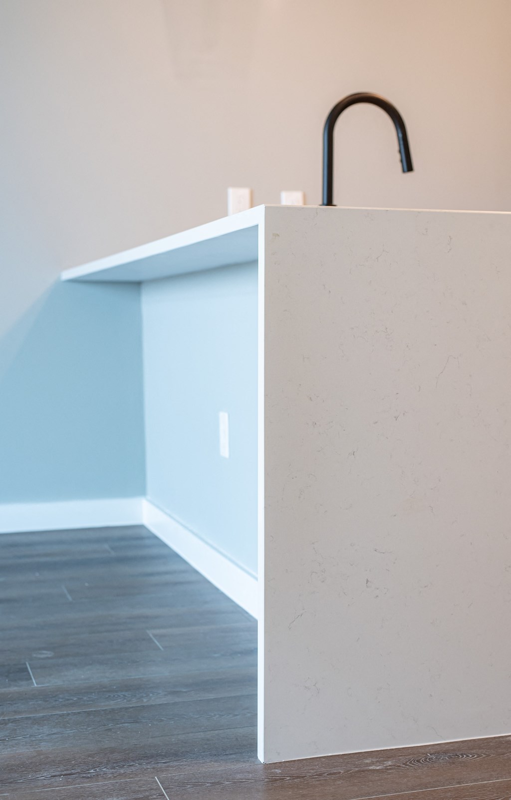 a kitchen with a counter top and a black faucet in it