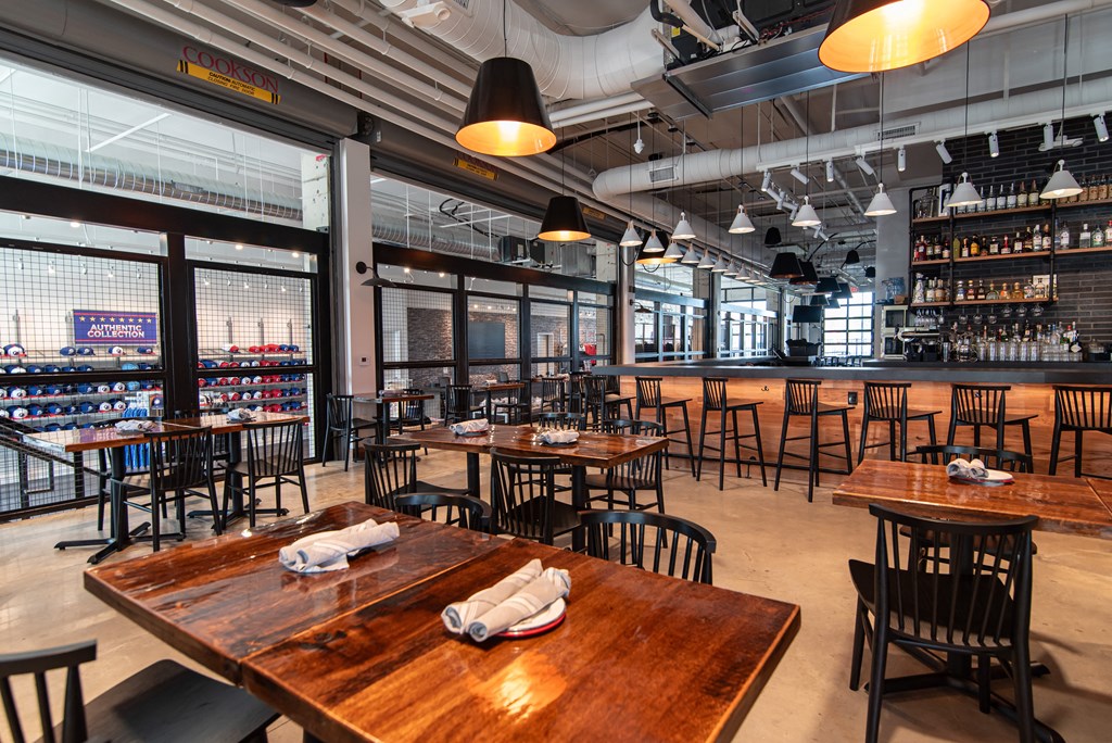 the interior of a restaurant with tables and chairs and a bar