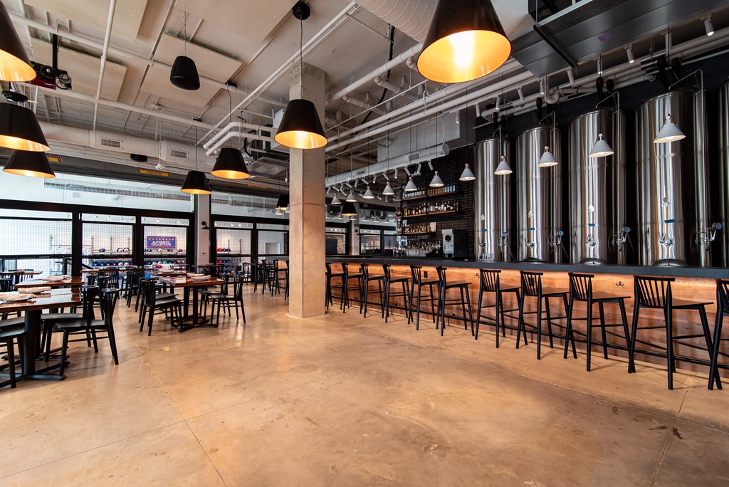 the bar and dining area of a restaurant with tables and chairs