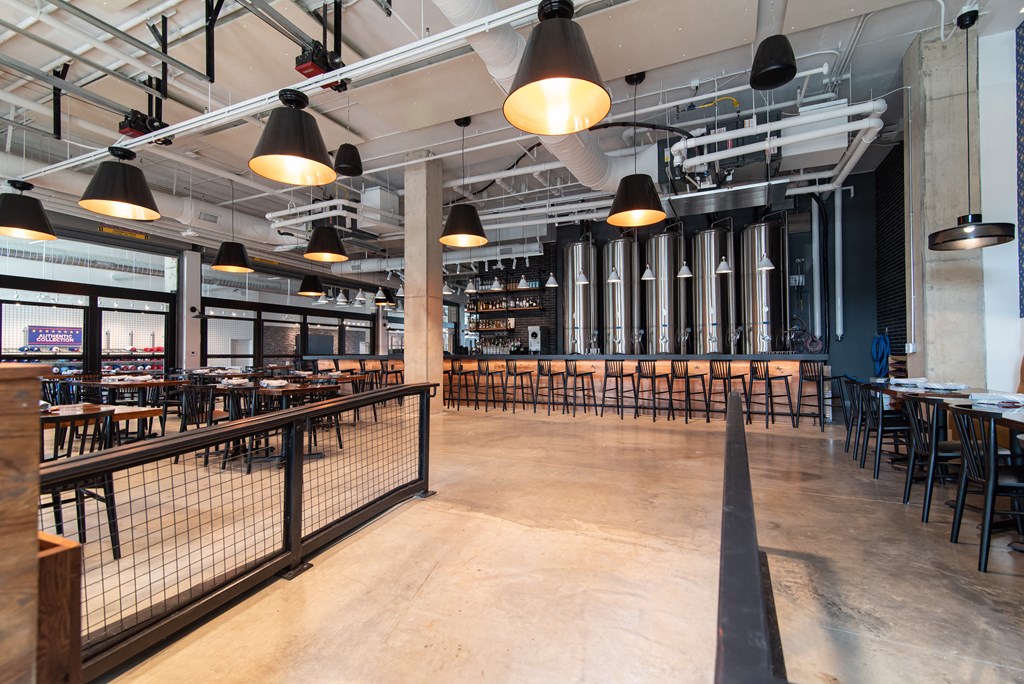 the interior of a restaurant with tables and chairs and a fence