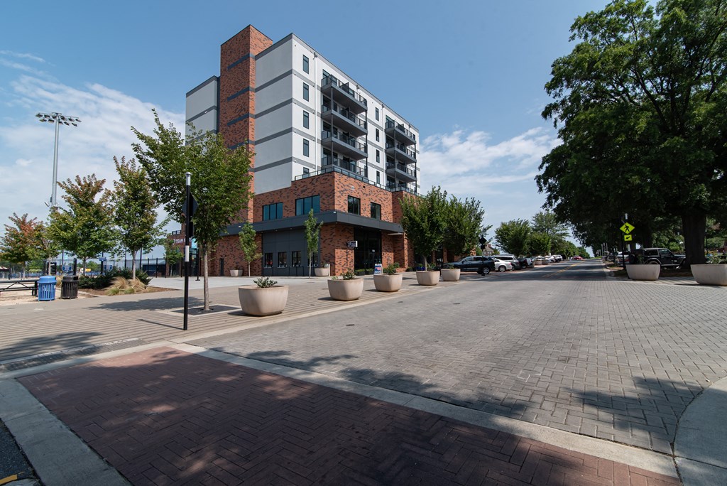 a city street with a building and trees on the side of it