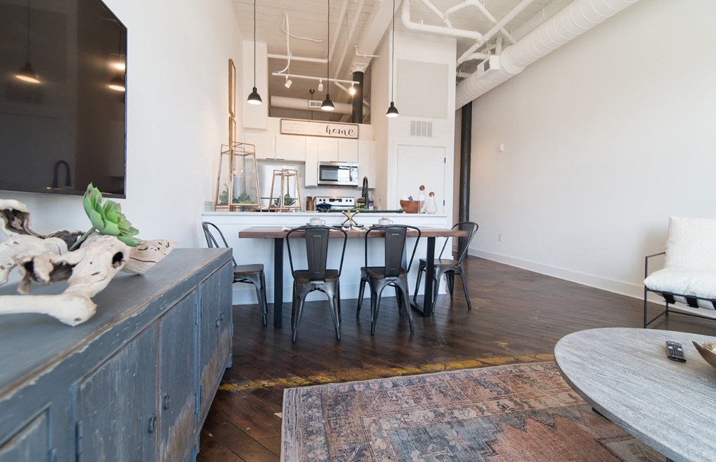 a kitchen and dining area with a table and chairs