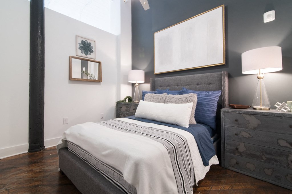 a bedroom with a bed and a dresser