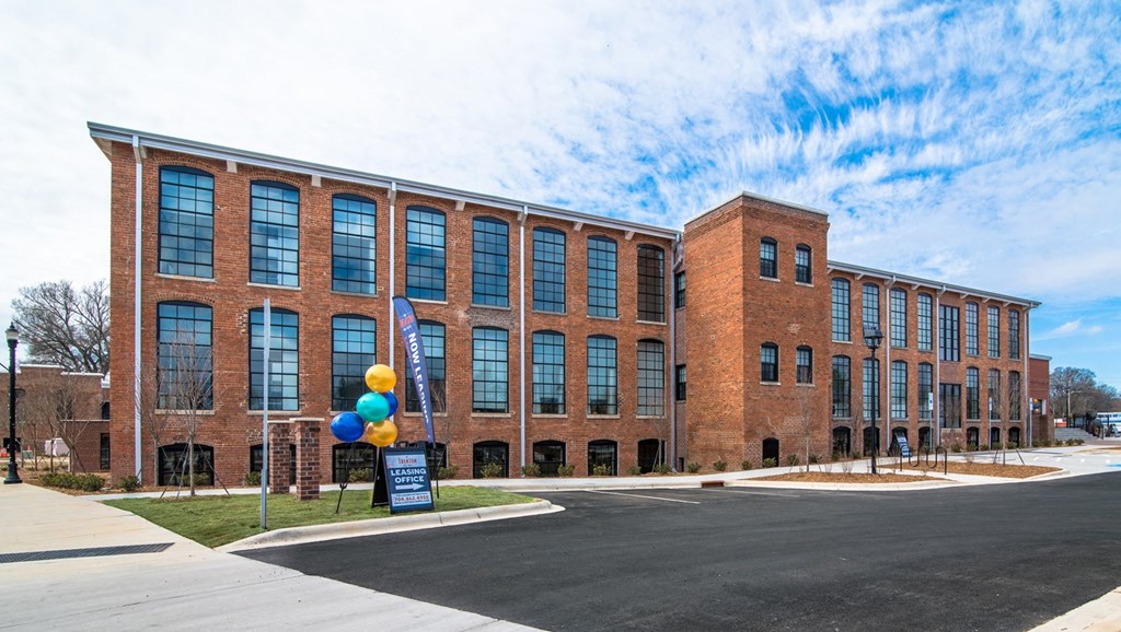 a large brick building with balloons in front of it