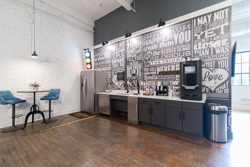 a white room with a counter and a wall covered in graffiti