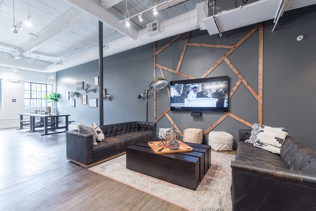 a living room with couches and a tv on the wall