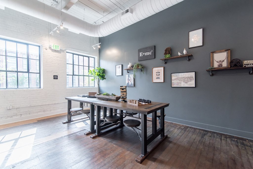 a dining room with a table and chairs in a room with blue walls and windows